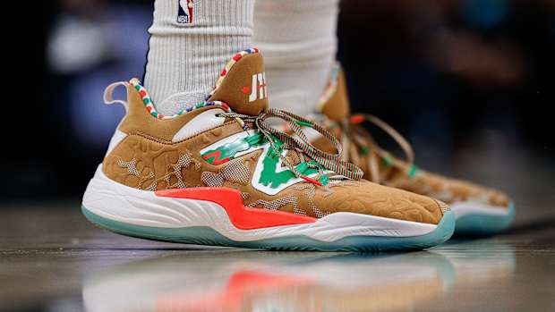 View of brown and green New Balance shoes.